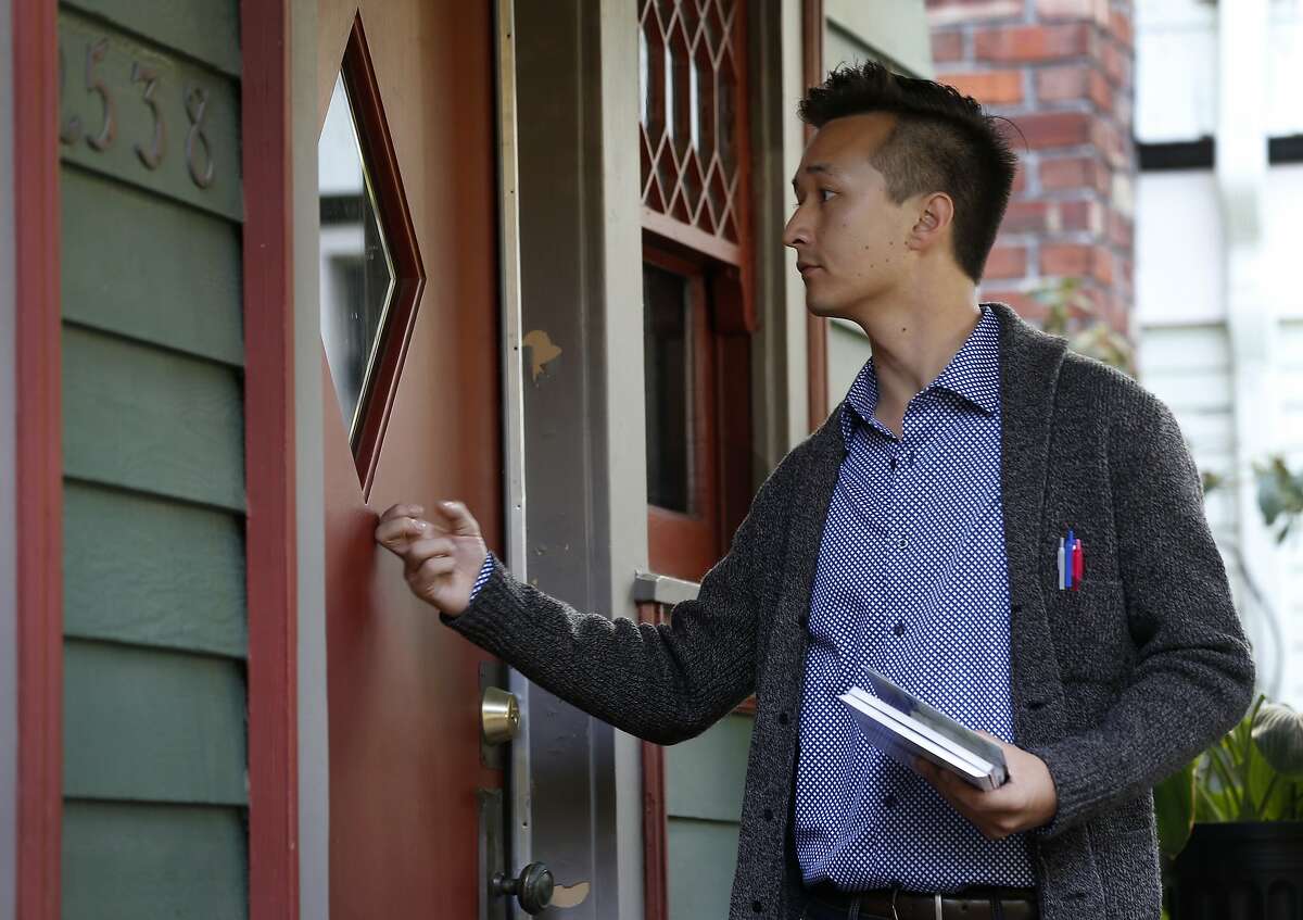 Rigel Robinson, a candidate running for the Berkeley City Council District 7 seat, knocks on doors while canvassing a neighborhood in Berkeley, Calif. on Saturday, Oct. 27, 2018.