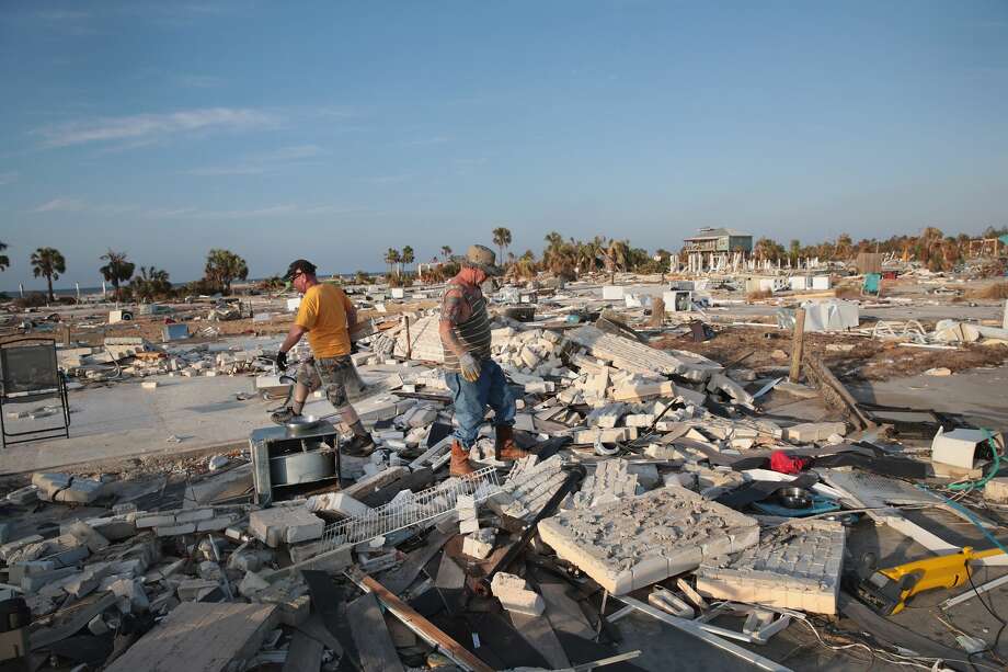 Not only property is being wiped out by climate change, but lives and lots and lots of money, too.
The United Nations Office for Disaster Risk Reduction states: "... between 1998 and 2017, climate-related and geophysical disasters killed 1.3 million people and left a further 4.4 billion injured, homeless, displaced or in need of emergency assistance. While the majority of fatalities were due to geophysical events, mostly earthquakes and tsunamis, 91% of all disasters were caused by floods, storms, droughts, heatwaves and other extreme weather events.
"In 1998-2017, disaster-hit countries experienced direct economic losses valued at US$ 2,908 billion, of which climate-related disasters caused US$ 2,245 billion or 77% of the total. This is up from 68% (US$ 895 billion) of losses (US$ 1,313 billion) reported between 1978 and 1997. Overall, reported losses from extreme weather events rose by 151% between these two 20-year periods."
Fighting climate change is expensive, but not fighting it is deadly and expensive.
Photo: Paul Koziol (L) and his brother Tom search for salvageable items in the home of their aunt after it was destroyed by Hurricane Michael on October 19, 2018 in Mexico Beach, Florida. Photo: Scott Olson/Getty Images