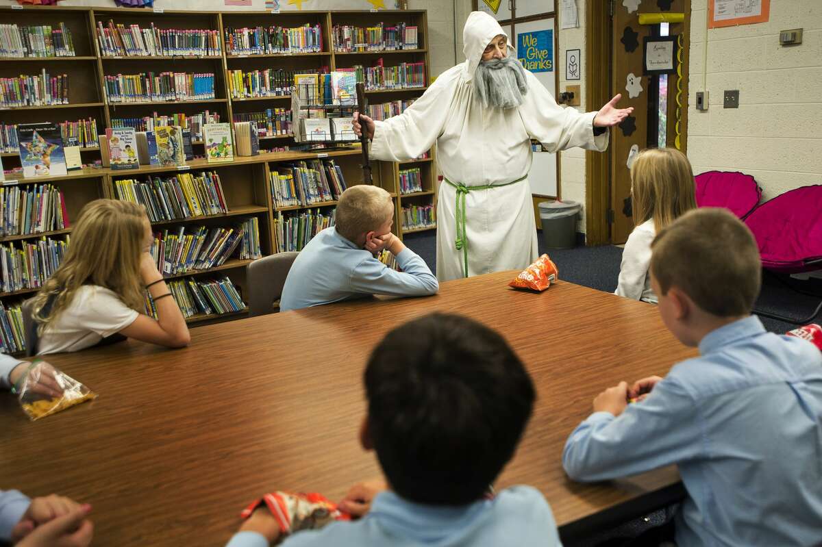 Midland resident Pete Comardy, dressed as St. Peter, speaks to a group of children at Blessed Sacrament School in celebration of All Saints' Day on Thursday, Nov. 1, 2018. (Katy Kildee/kkildee@mdn.net)