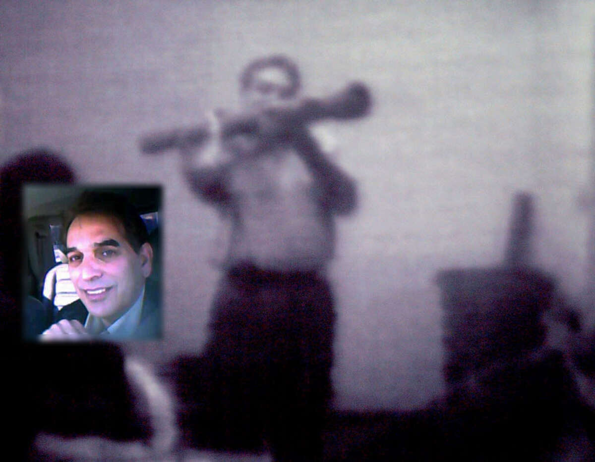 A surveillance videotape shows informant Shahed Hussain wielding an inoperable shoulder-fired rocket launcher to a suspect in a federal terrorism sting in Albany involving Mohammed Hossain and Yassin Aref. Hussain, inset photo, is shown in another  surveillance video. (U.S. Attorney's Office / Times Union archive)