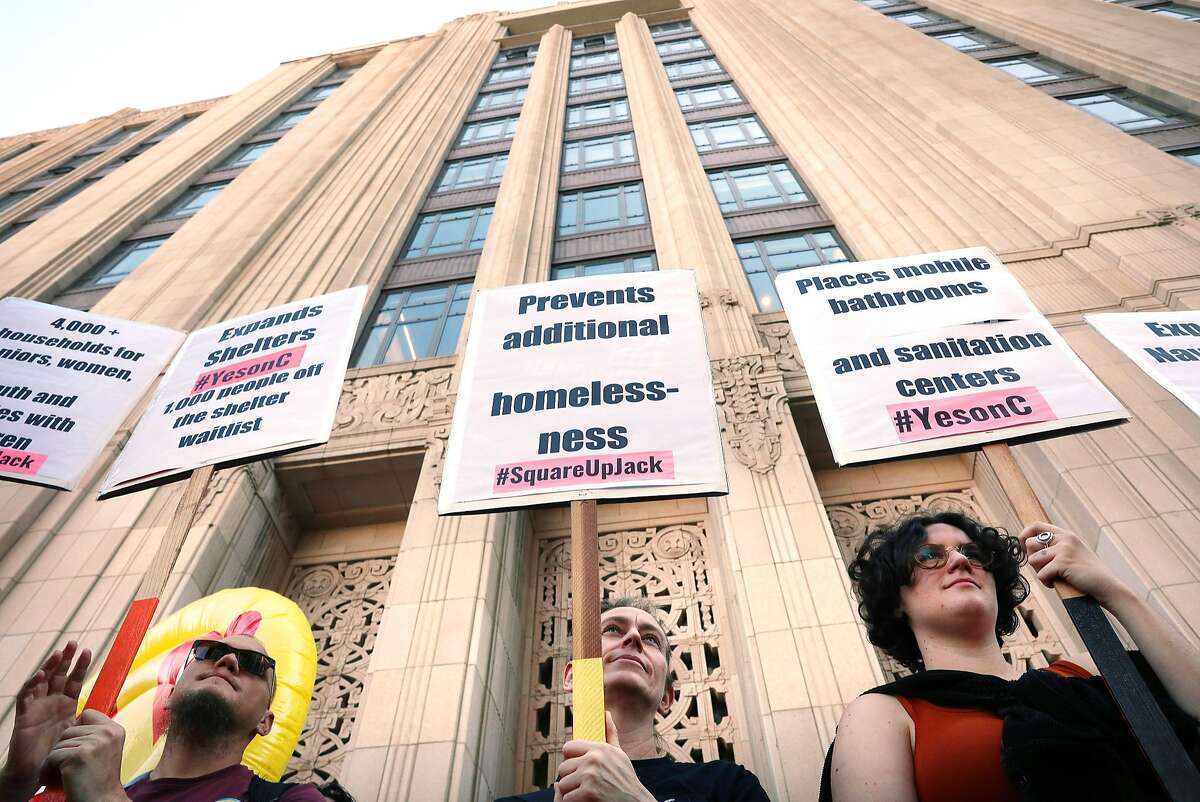 Anakh Sul Rama (l to r), Renee Curran, Emily Garcia and other demonstrators hold signs during a Yes on C rally in front of the entrance to Twitter headquarters on Thursday, October 25, 2018 in San Francisco, Calif.