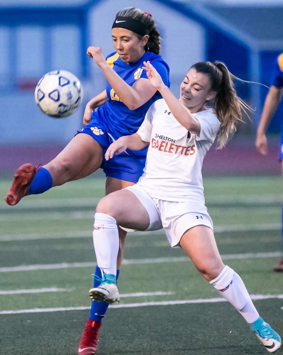 Mercy’s Kaitlyn Malloy and Shelton’s Ezabel Rosa battle for the ball during Thursday’s SCC championship game.