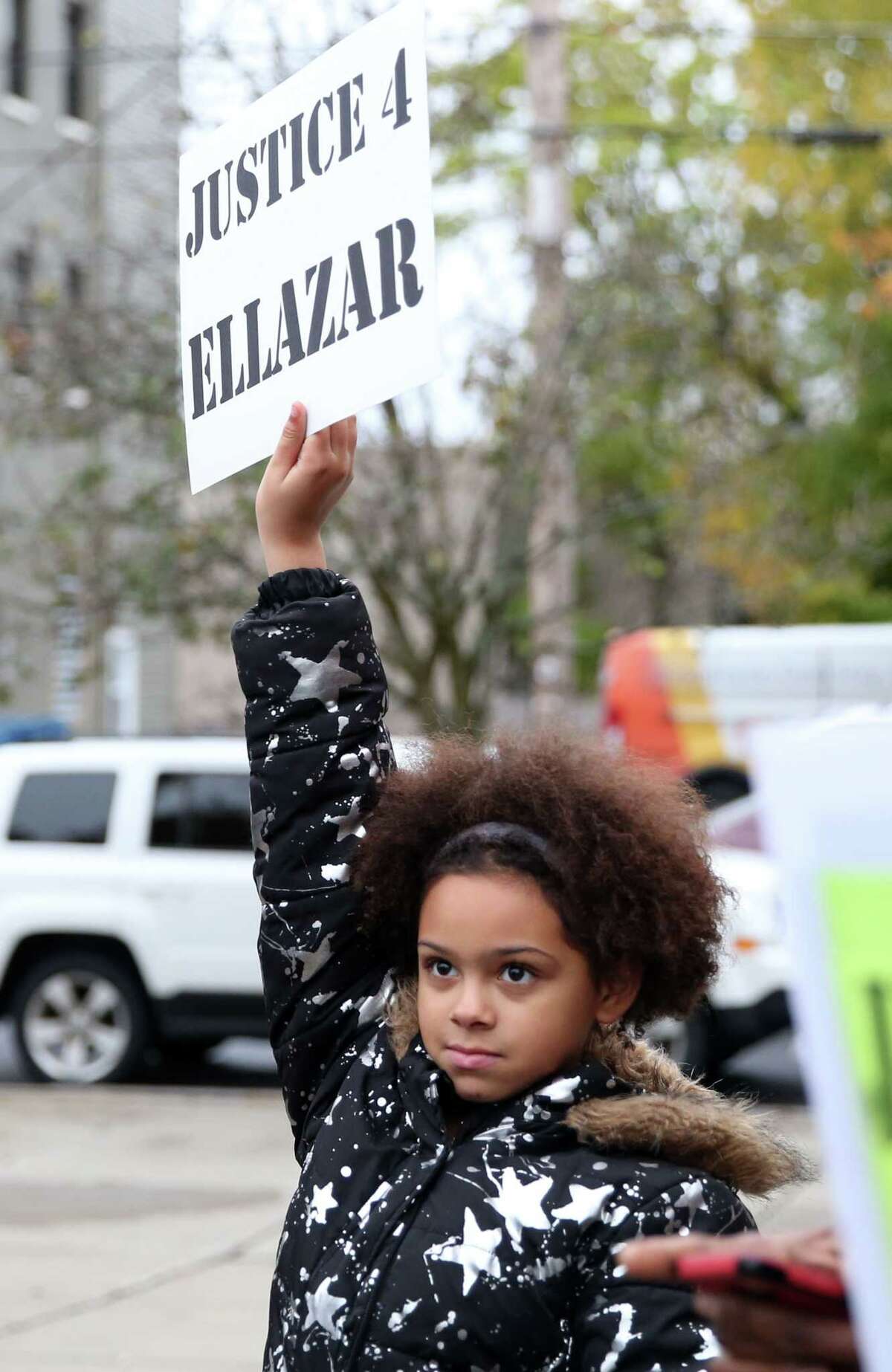 Kamara Fulton, 10, holds up a sign during a rally for Ellazar Williams Thursday, Nov. 1, 2018 at the Albany Police Department Headquarters. (Phoebe Sheehan/Special to the Times Union)