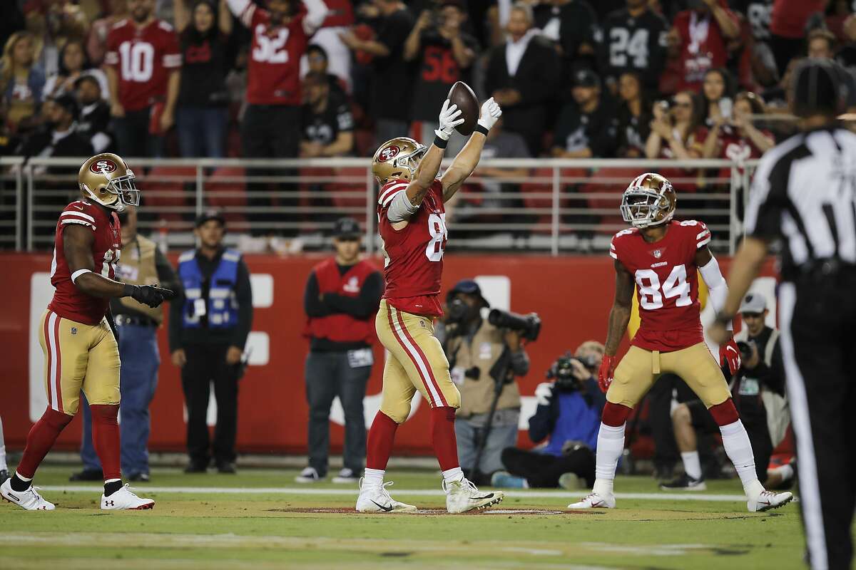 San Francisco 49ers tight end George Kittle, left, celebrates next to wide receiver Kendrick Bourne after scoring against the Oakland Raiders during the second half of an NFL football game in Santa Clara, Calif., Thursday, Nov. 1, 2018. (AP Photo/John Hefti)