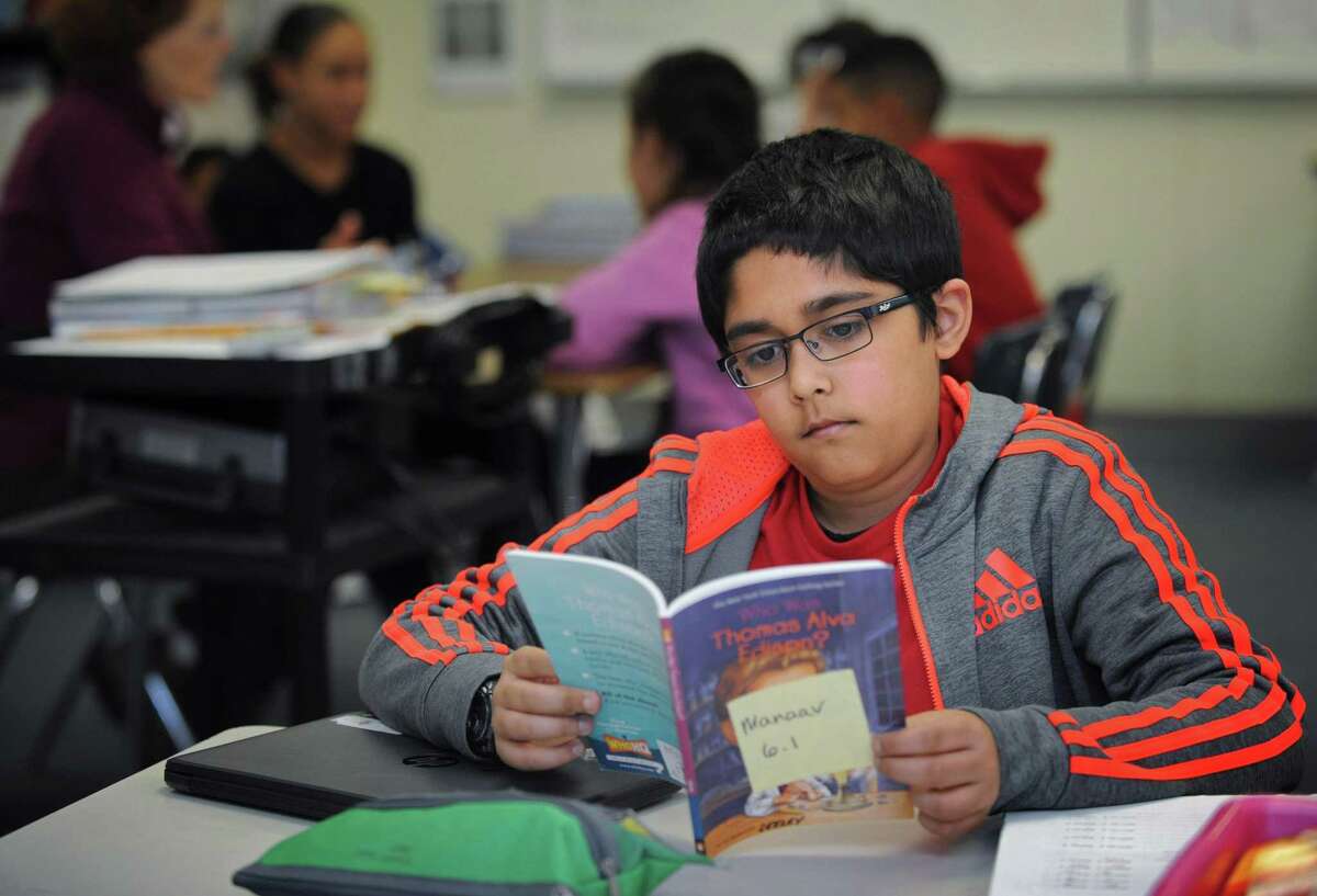 Student Maanav Patel reads his book in the individualized reading rotation as part of the Read 180 program during Mrs. Seeley's 6th grade class Tuesday, October 30, 2018, at Ponus Ridge Middle School in Norwalk, Conn.