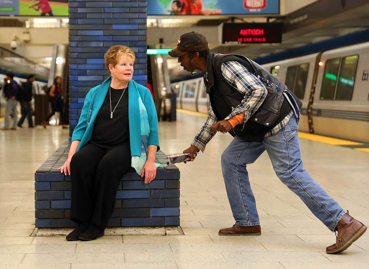 BART General Manager Grace Crunican talks with passenger Gene H. at the 19th Street station on Friday, Nov. 2, 2018, in Oakland, Calif.