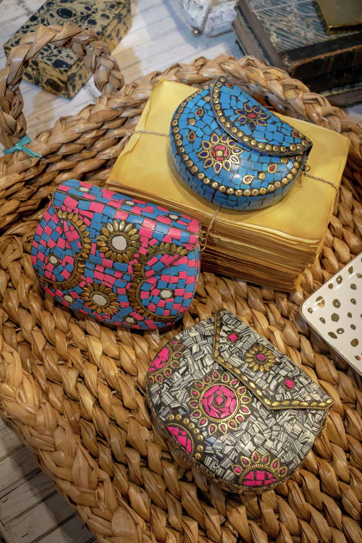 These hard-sided clutches are inlaid with colorful stones and brass metal work and were made in Bhutan in the Himalayas. They can be found in the Laurier Blanc antiques and decor store on Bissonet in Houston.