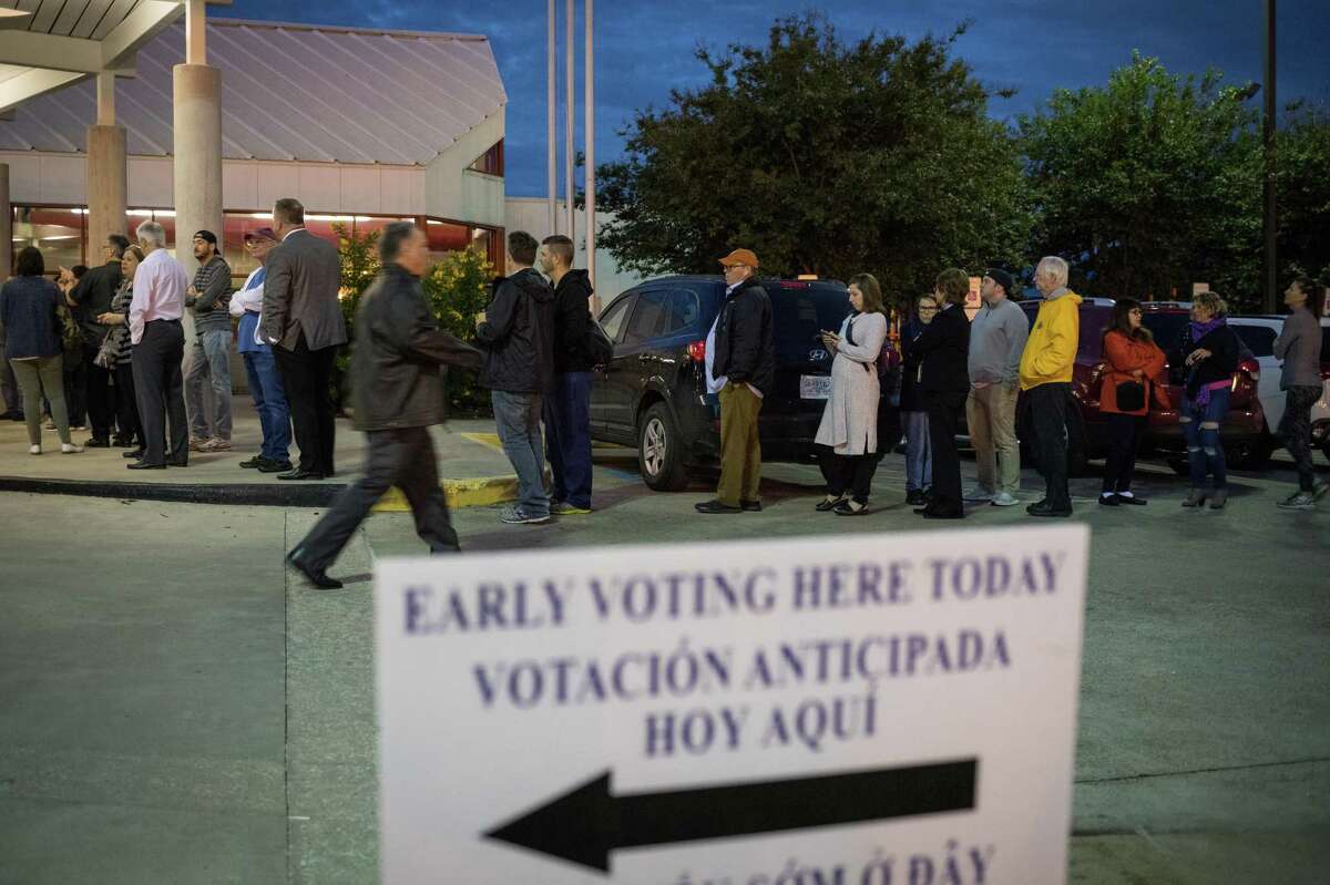 People wait in line to vote at a polling place on the first day of early voting on October 22, 2018 in Houston(Photo by Loren Elliott/Getty Images)