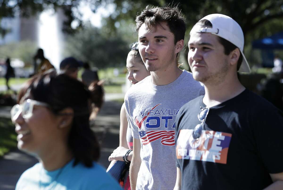 In this Wednesday, Oct. 31, 2018 photo, David Hogg, center, a student who survived the Stoneman Douglas High School shooting walks with volunteers to a polling place on campus during a Vote for Our Lives event at the University of Central Florida in Orlando, Fla. Nine months after 17 classmates and teachers were gunned down at their Florida school, Parkland students are finally facing the moment they’ve been leading up to with marches, school walkouts and voter-registration events throughout the country: their first Election Day.(AP Photo/John Raoux)