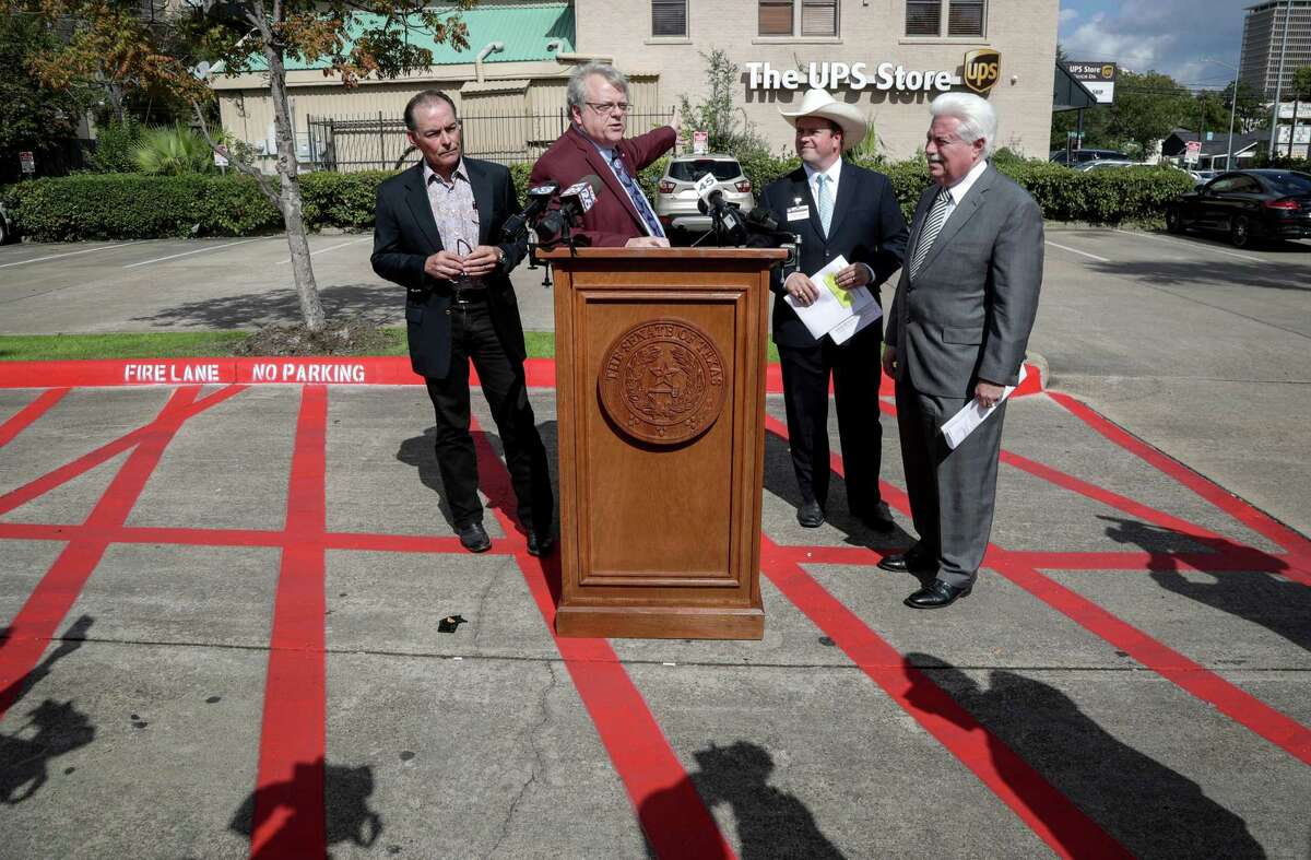 State Sen. Paul Bettencourt, second from left, speaks about alleged voter registration problems during a press conference with Orlando Sanchez, Harris County treasurer, left, Chris Daniel, Harris County district clerk, second from right, and Stan Stanart, Harris County clerk, right, in the parking lot of a UPS store, Tuesday, Oct. 30, 2018, in Houston. Bettencourt said 84 people are registered to vote at the UPS store through post office boxes.
