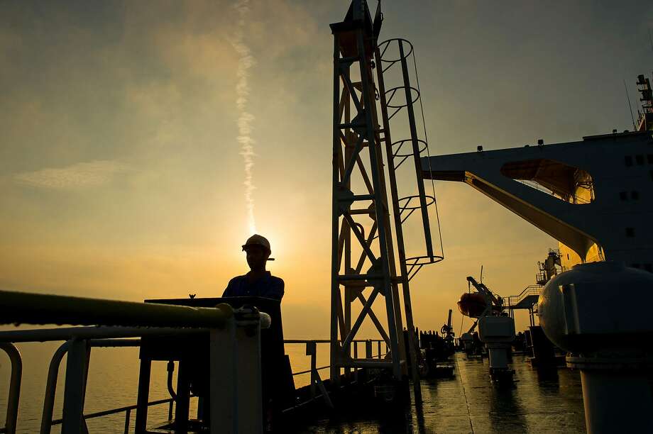 A crew member is on the deck of the tanker