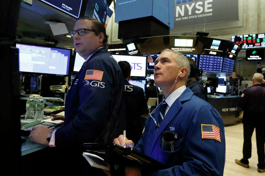 FEATURE - On October 24, 2018, Gregg Maloney, an archive photo specialist, on the left, and dealer Timothy Nick work on the floor of the New York Stock Exchange. The US stock market opens at 9:30 am EDT Friday, November 2nd. (Photo AP / Richard Drew, File) Photo: Richard Drew / Copyright 2018 The Associated Press. All rights reserved