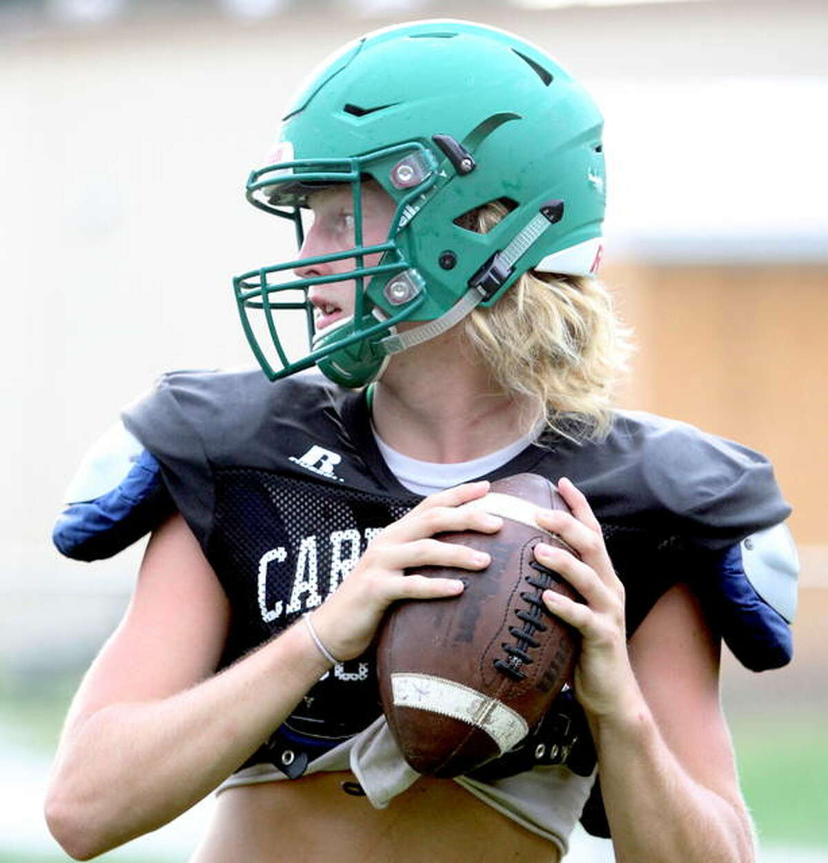 Carrollton’s Hunter Flowers looks for a receiver during preseason practice. The Hawks host Camp Point Central today in the second round of the IHSA Class 1A playoffs.