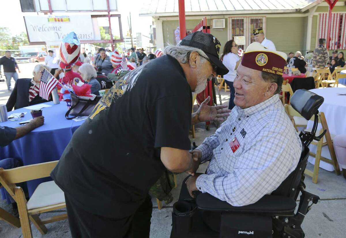Vietnam veterans Fernando Herrera (left) and Armando Albarran greet one another as vets are honored at the gathering, You Are Not Forgotten, on the Westside on Saturday, Nov. 3, 2018. Herrera is a decorated veteran with a Distinguished Service Cross, four Bronze Stars and a Purple Heart. Albarran lost his legs in mine explosion while serving in the U.S. Army in Vietnam in 1966 and is the past national commander of Disabled American Vets (DAV). In conjunction with the event, re-enactors with San Antonio Living History also fired a cannon and muskets to reflect the history of the Battle of Alazan Creek as part of the city's 300th celebration. In its third year, event organizers also opened the gathering to all military veterans. A highlight is a mural dedicated to Vietnam veterans painted by local artist Michael Roman. (Kin Man Hui/San Antonio Express-News)