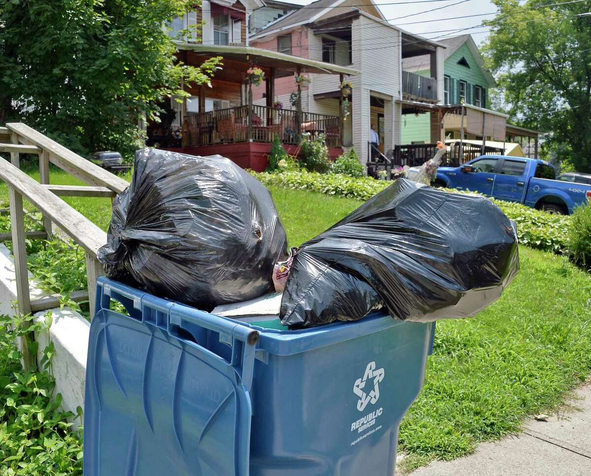 Trash cans outside a house on East Sunnyside Tuesday August 7, 2018 in Troy, NY. (John Carl D'Annibale/Times Union)