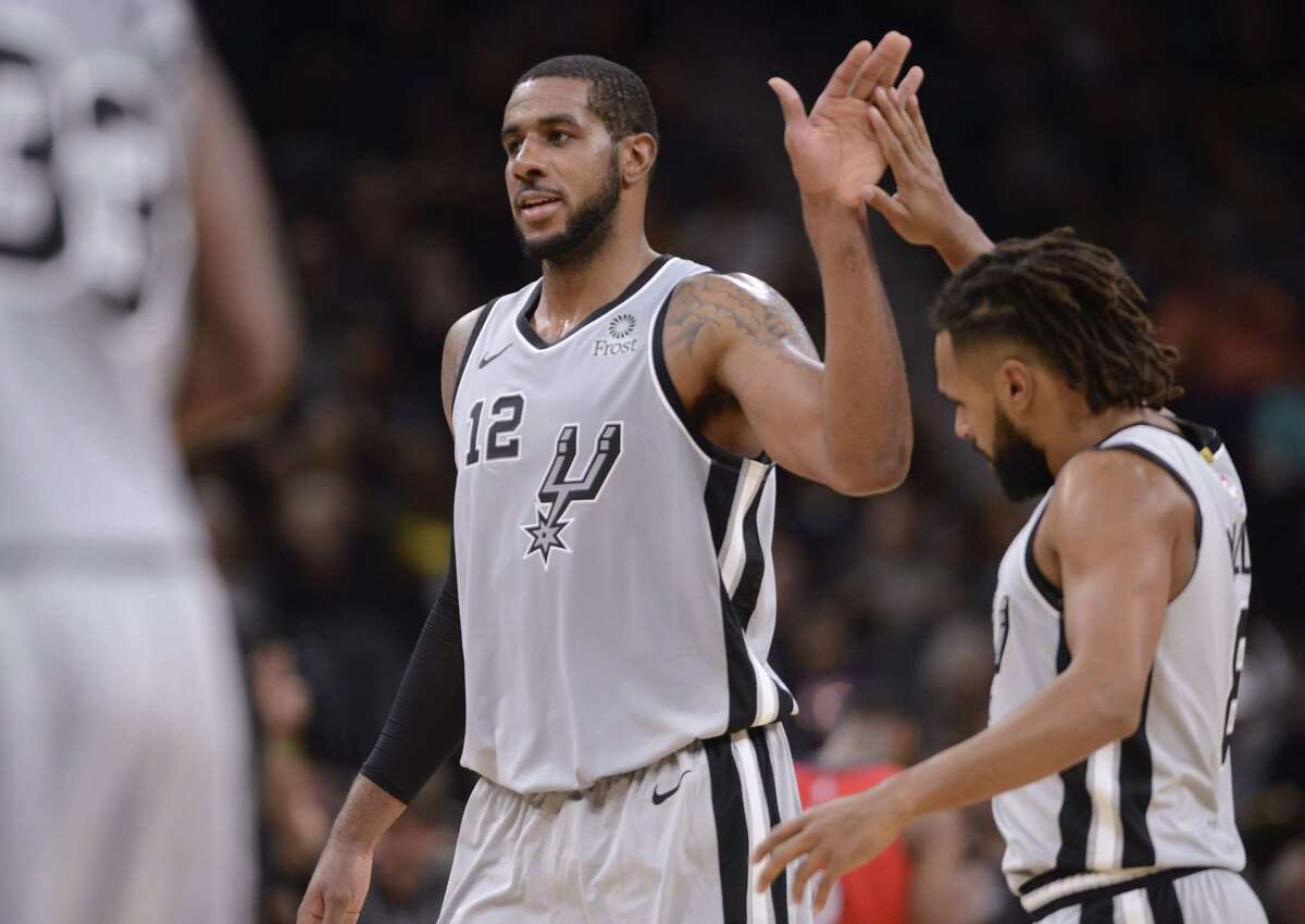 San Antonio Spurs players LaMarcus Aldridge (12) and Patty Mills celebrate as time winds down on their 109-95 victory over the New Orleans Pelicans in the AT&T Center on Saturday, Nov. 3, 2018. Aldridge scored 22 points while Mills scored 15 and had seven assists.