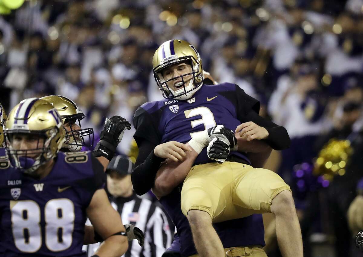 Washington quarterback Jake Browning (3) is lifted in the air in celebration of his touchdown run against Stanford during the first half of an NCAA college football game Saturday, Nov. 3, 2018, in Seattle. (AP Photo/Elaine Thompson)
