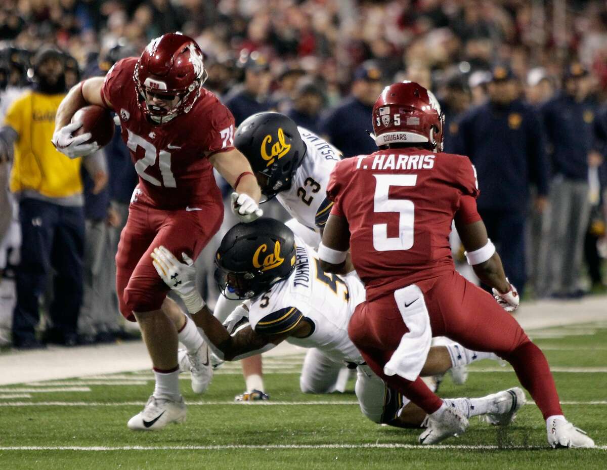 PULLMAN, WA - NOVEMBER 03: Max Borghi #21 of the Washington State Cougars carries the ball against Malik Psalms #23 and Trey Turner III #5 of the California Golden Bears in the first half at Martin Stadium on November 3, 2018 in Pullman, Washington. (Photo by William Mancebo/Getty Images)