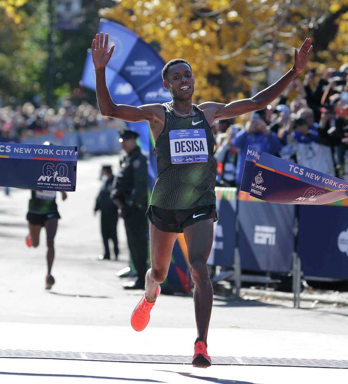 Lelisa Desisa, of Ethiopia, crosses the finish line first in the men's division of the New York City Marathon in New York, Sunday, Nov. 4, 2018.