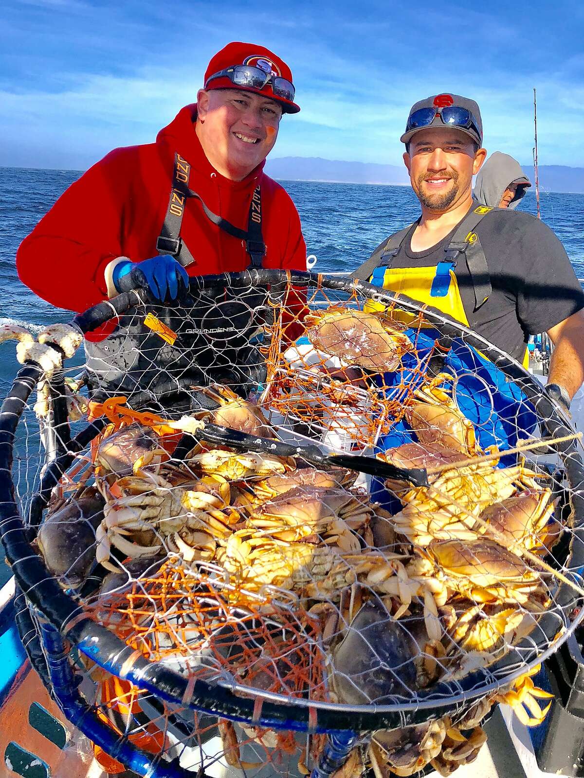 Peter Akimo and Mike Juanes show off of a pot full of Dungeness crab taken in 190 feet of water Sunday off San Gregorio on the Huli-Cat out of Pillar Point Harbor