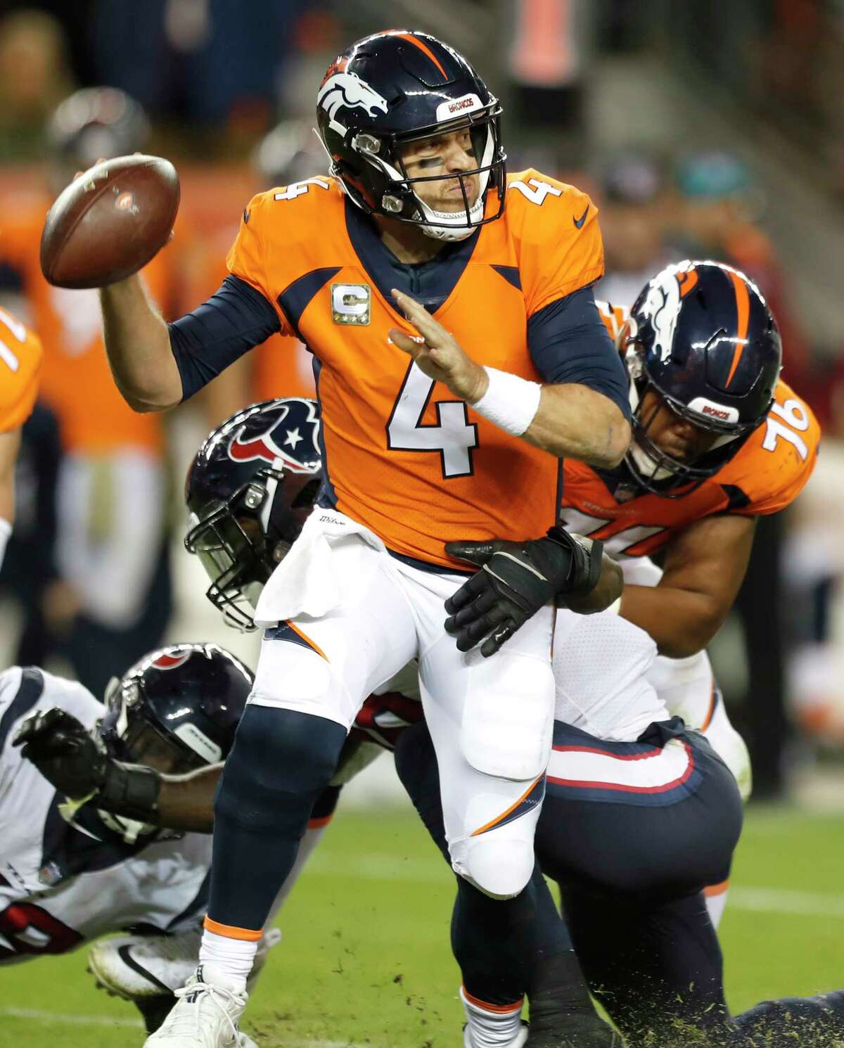Denver Broncos quarterback Case Keenum (4) is hit by Houston Texans outside linebacker Jadeveon Clowney (90) during the fourth quarter of an NFL football game at Broncos Stadium at Mile High on Sunday, Nov. 4, 2018, in Denver.