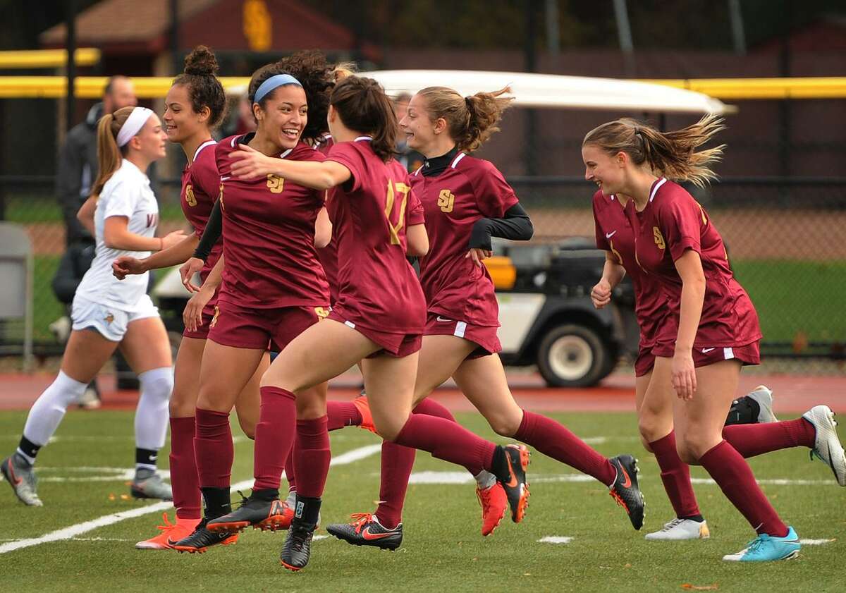 St. Joseph teammates celebrate a goal by Jessica Mazo, facing, during the opening minutes of their victory over Westhill in the Class LL girls soccer state tournament at St. Joseph High School in Trumbull, Conn. on Monday, November 5, 2018.