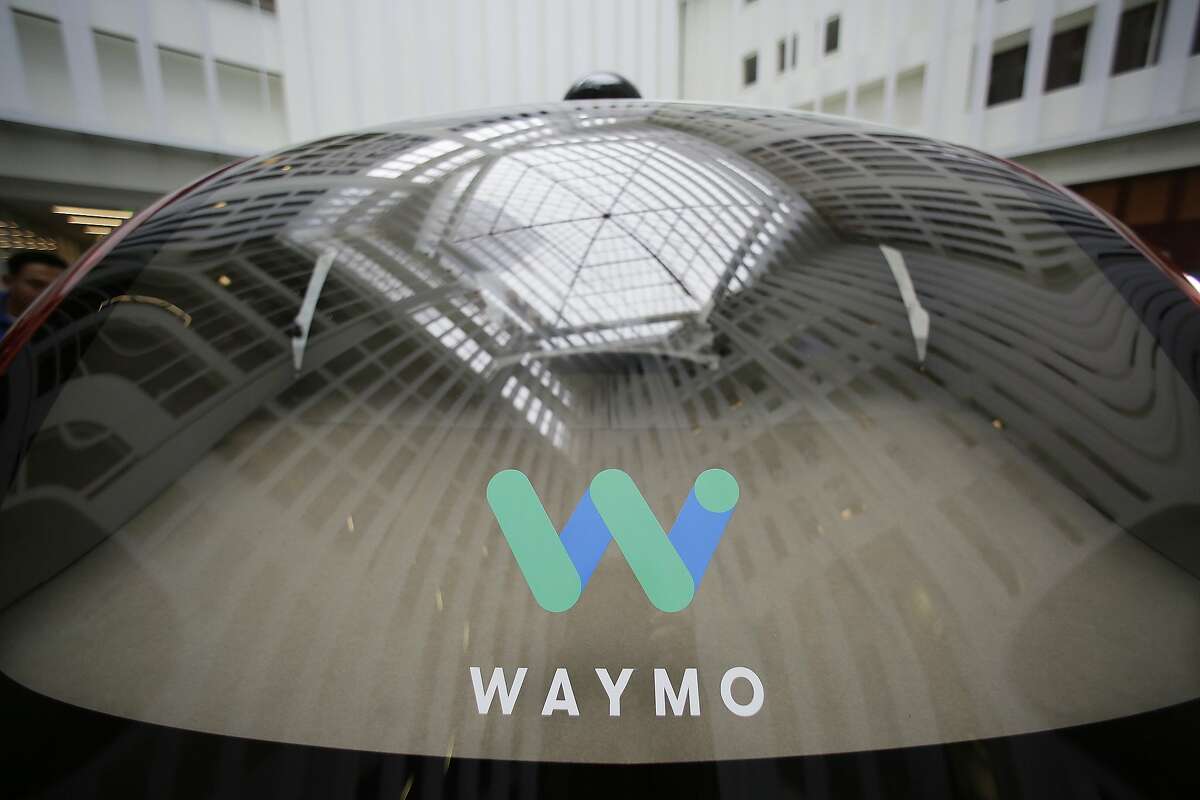 FILE - In this Dec. 13, 2016, file photo, a skylight is reflected in the rear window of a Waymo driverless car during a Google event in San Francisco. Google's robotic car spin-off Waymo is poised to become the first to test fully driverless vehicles on California's public roads. (AP Photo/Eric Risberg, File)