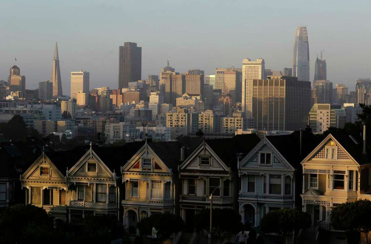 FILE - This July 11, 2017, file photo, shows the skyline beyond a row of Victorian houses in San Francisco.
