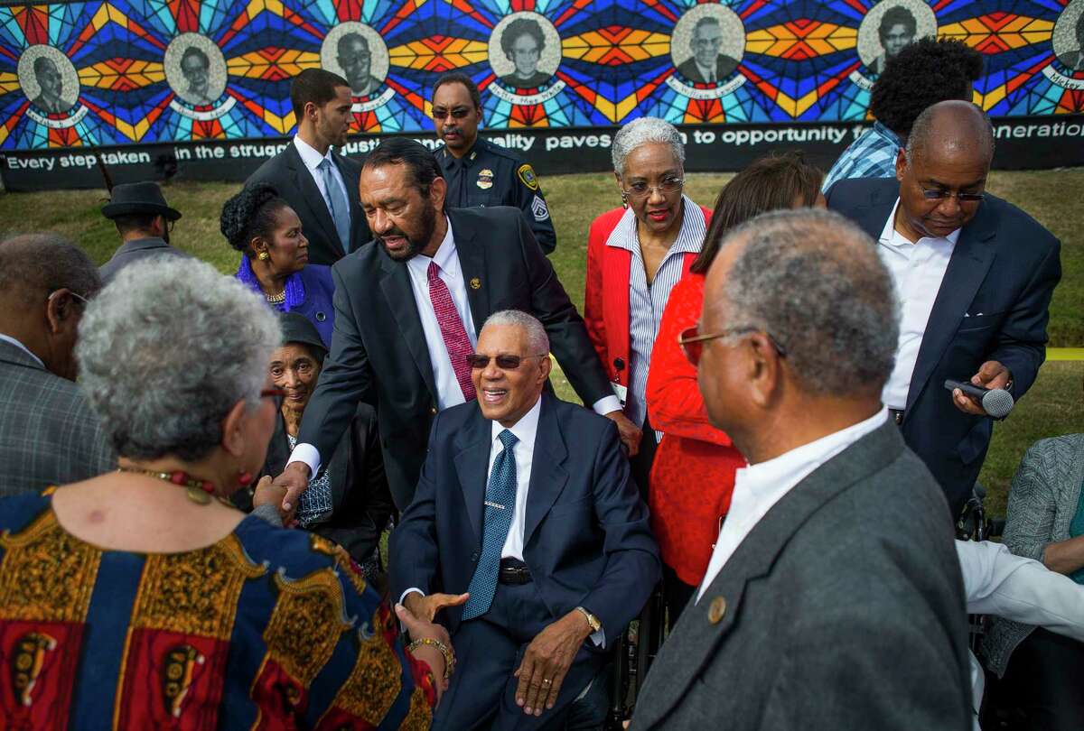 People greet the Rev. William Lawson during the dedication of The Sacred Struggles / Vibrant Justice Mural along the Columbia Tap trail behind the Pilgrim Congregational United Church of Christ, Monday, Nov. 5, 2018 in Houston. The mural pays tribute to eight of Houston's African American civil rights leaders.