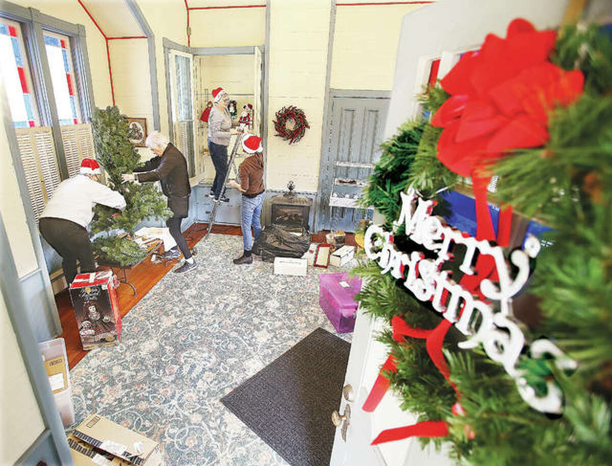 From the left, Lucy Playhouse Association members Debbie Schuneman, Margaret Hopkins, Chris Alford and Debbie Rowden start decorating Monday for the annual Victorian Christmas at the Lucy Haskell Playhouse, 1211 Henry St. in Alton. The Dec. 1 event features Santa and Mrs. Claus on hand to greet children in the historic playhouse from noon until 2 p.m.