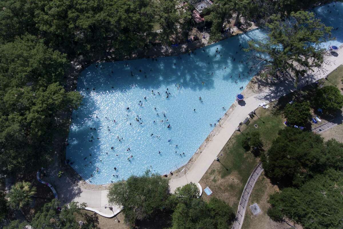 People swim in the pool at San Pedro Springs Park.