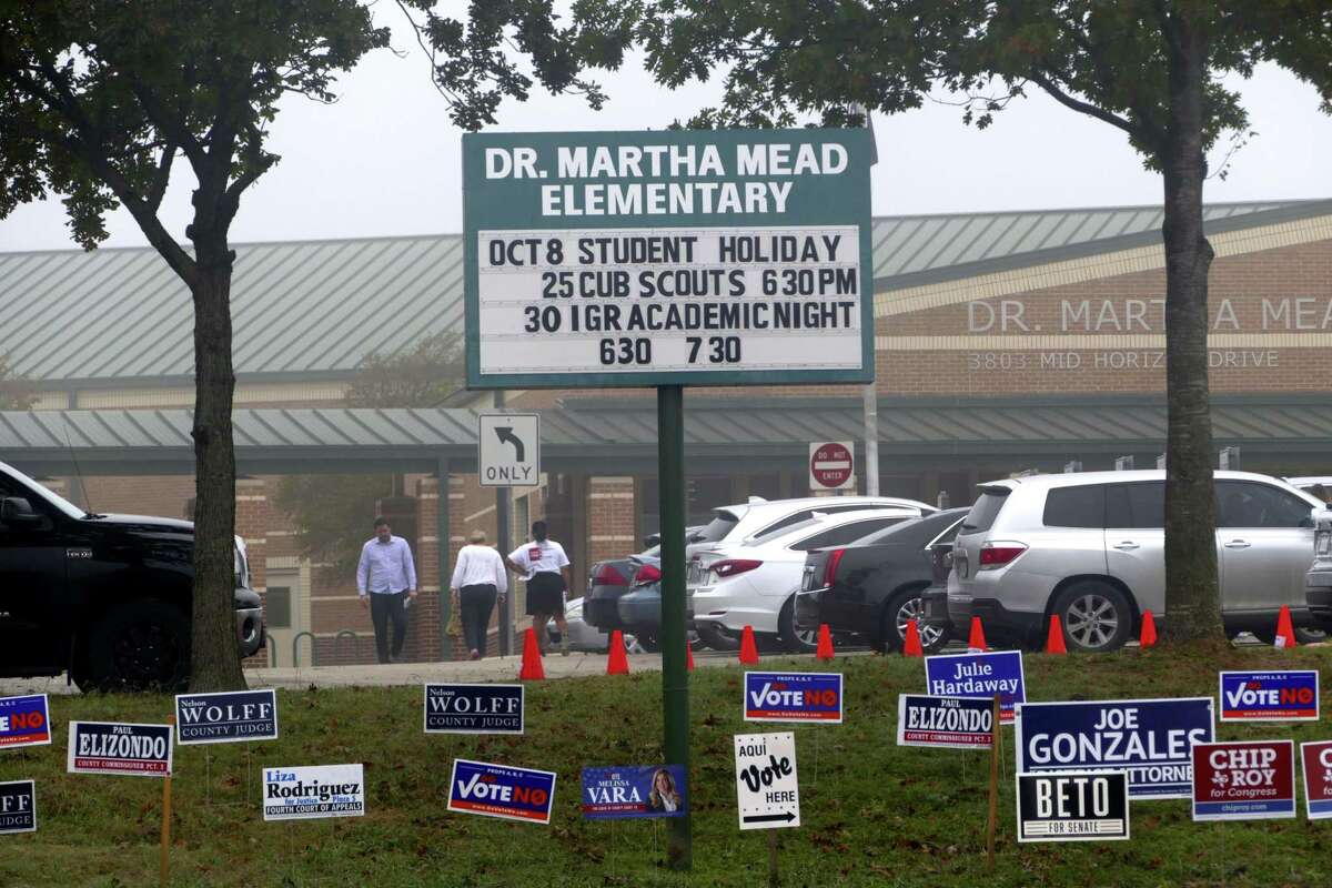 Voters and arrive and leave Dr. Martha Mead Elementary School, a polling place near Medical Center, on Tuesday, Nov. 6, 2018.