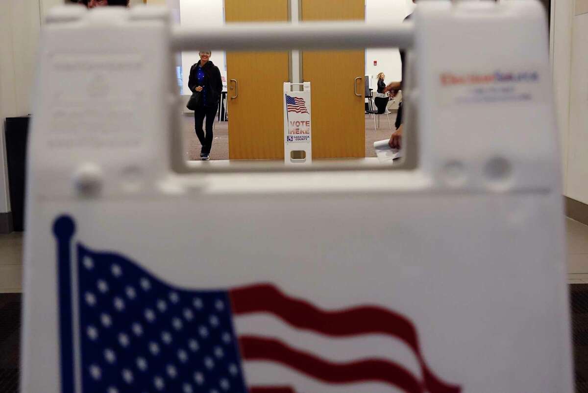FILE. Voters make their way in and out of a room at the Saratoga City Center in 2018, in Saratoga Springs, N.Y. (Paul Buckowski/Times Union)