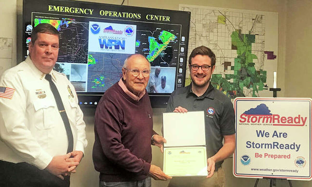 NWS Warning Coordination Meteorologist Kevin Deitsch, right, presents Godfrey Mayor Mike McCormick and Village Public Safety Administrator Christopher Sichra with the National Weather Service’s “StormReady City” recognition award.