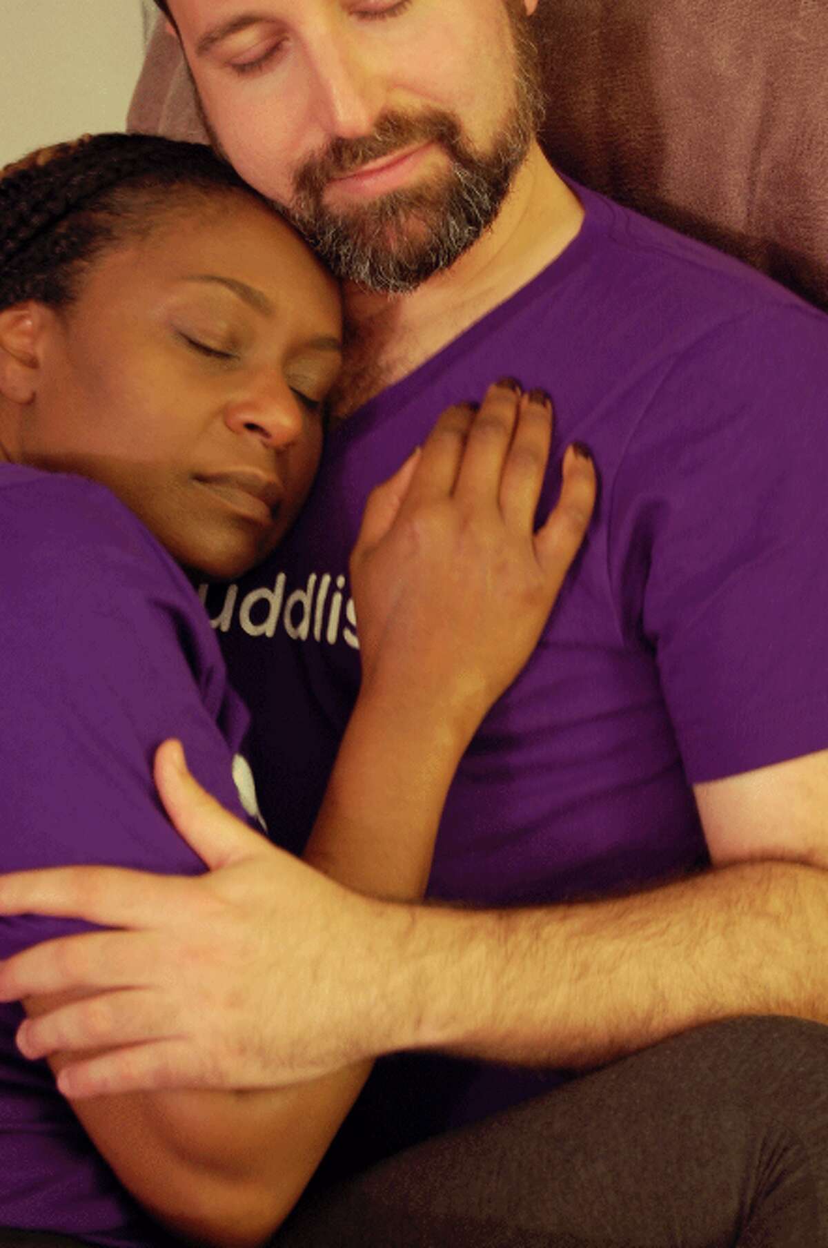 Yoni Alkan, a certified Cuddlist and a Cuddle Party facilitator, cuddles with a client.