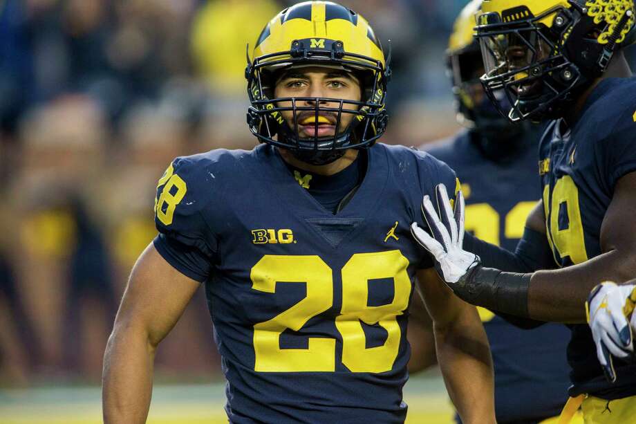 michigan defensive back brandon watson 28 celebrates with defensive lineman kwity paye right - Christmas Day College Football michigan defensive back brandon watson 28 celebrates with defensive lineman kwity paye right - Christmas Day College Football