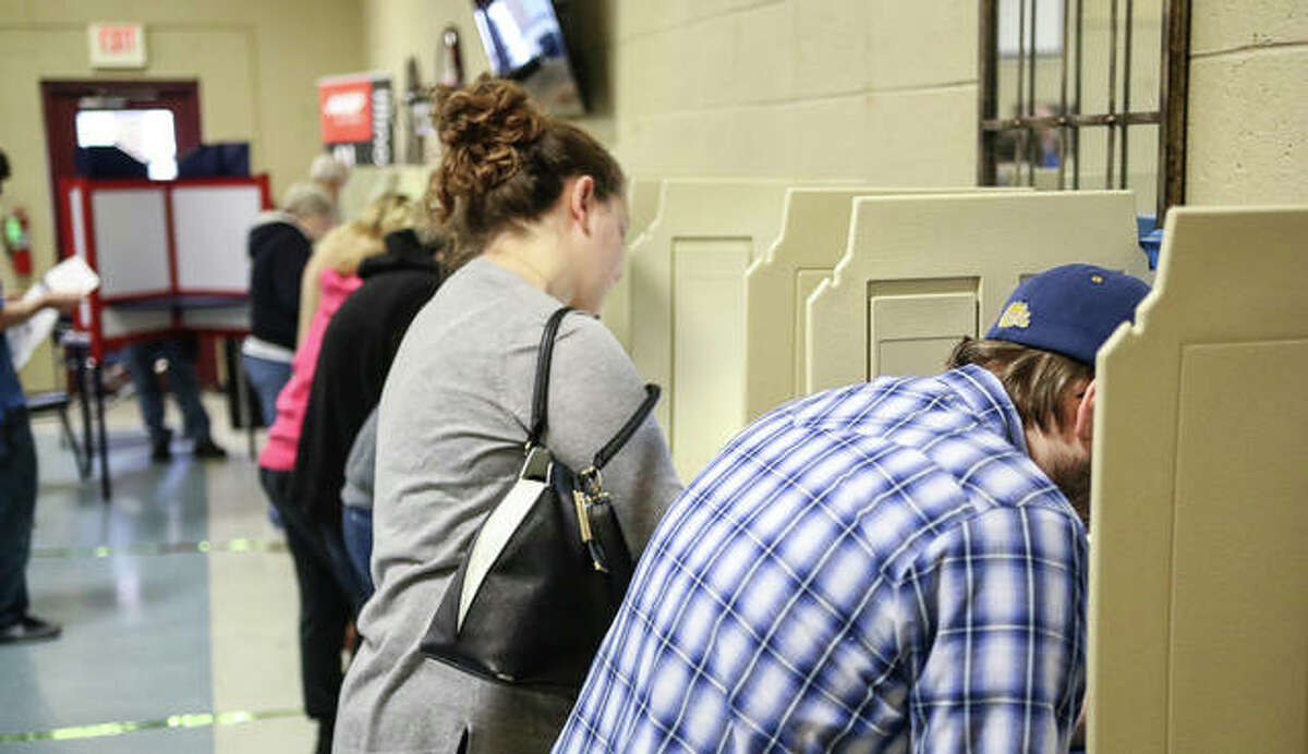 Voters fill out their ballots at a full Senior Services Plus in Alton Tuesday.