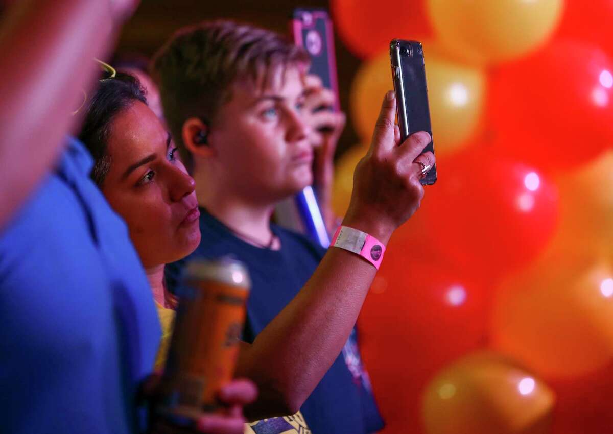 Prop B supporters listen and record as HPFFA members announced results during a watch party at the White Oak Music Hall Tuesday, Nov. 6, 2018, in Houston.