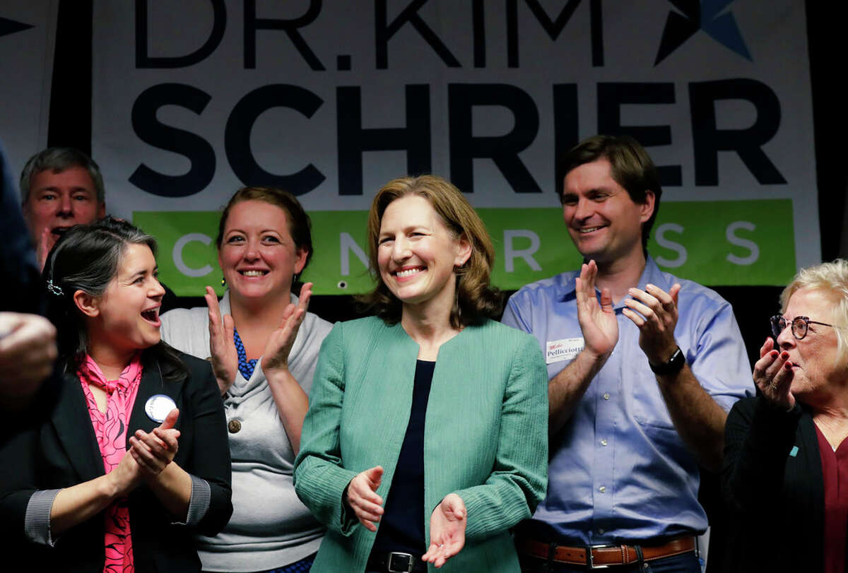 Dr. Kim Schrier, new U.S. House member from the 8th District, stands with local and state race candidates on election night.