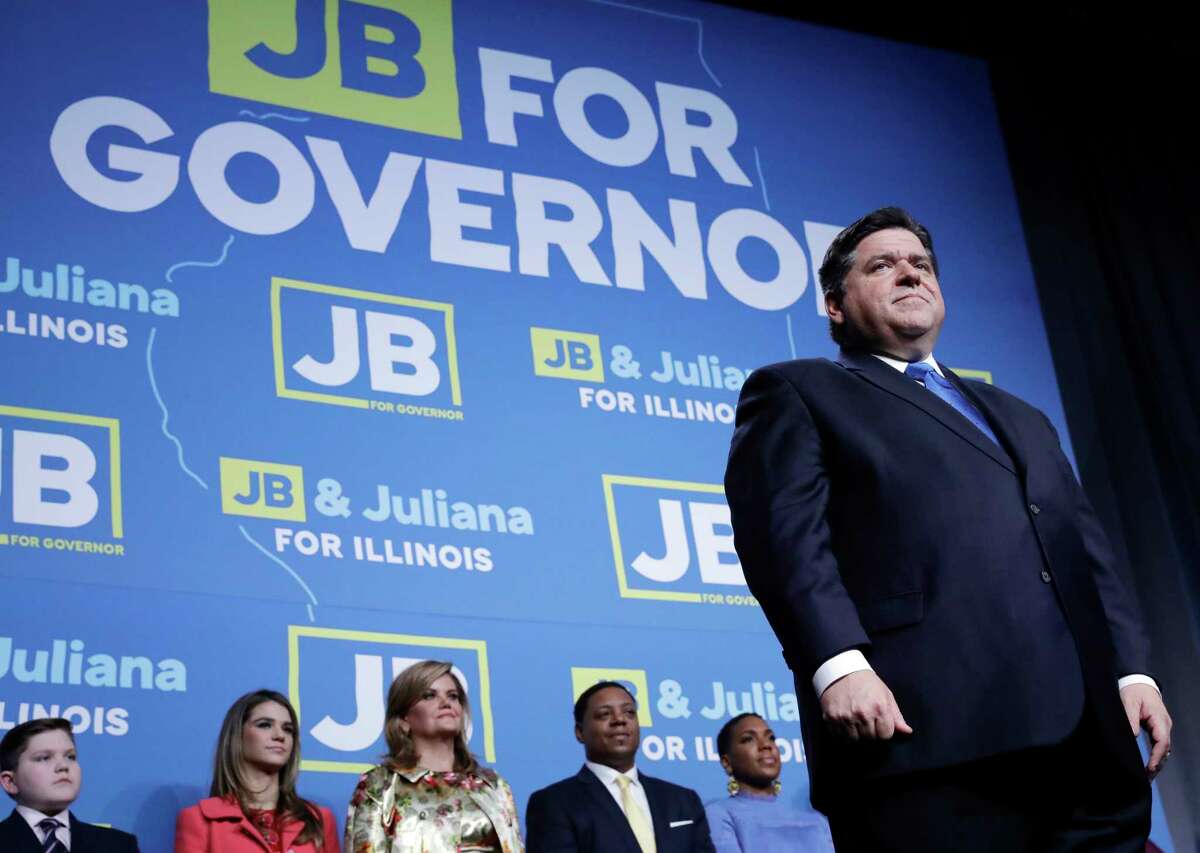 Democratic gubernatorial candidate J.B. Pritzker, right, looks at supporters after he wass elected as Illinois governor over Republican incumbent Bruce Rauner in Chicago, Tuesday, Nov. 6, 2018.