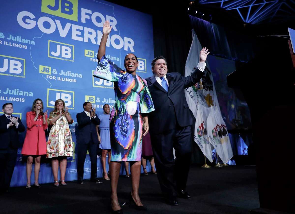 Democratic gubernatorial candidate J.B. Pritzker, right, and his running mate Lt. Governor candidate Juliana Stratton celebrate as they wave to supporters after Pritzker is elected as Illinois governor over Republican incumbent Bruce Rauner in Chicago, Tuesday, Nov. 6, 2018.