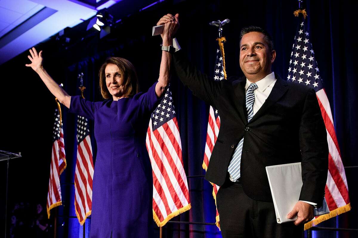 House Minority Leader Nancy Pelosi (D-San Francisco) and Rep. Ben Ray Lujan (D-NM), the DCCC Chairman, celebrate a projected Democratic Party takeover of the House of Representatives on Nov. 7 in Washington, D.C.