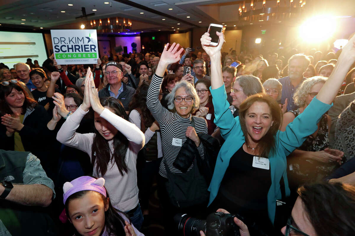 Supporters cheer Congressional candidate Kim Schrier as she addresses the crowd at an election night party for Democrats Tuesday, Nov. 6, 2018, in Bellevue, Wash. (AP Photo/Elaine Thompson)