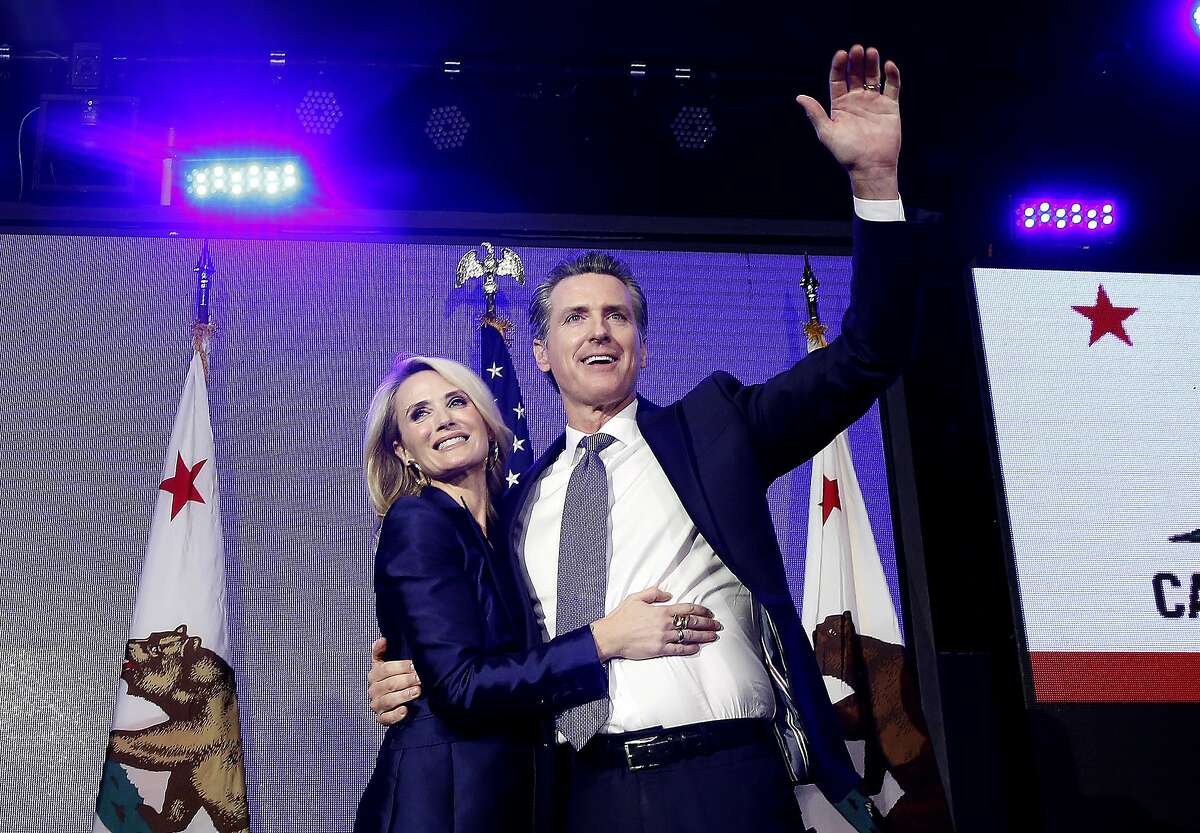 Lt. Gov Gavin Newsom, a Democrat, hugs his wife,Jennifer Siebel Newsom as he celebrates at an election night party after he defeated Republican opponent John Cox to become 40th governor of California Tuesday, Nov. 6, 2018, in Los Angeles, Calif. (AP Photo/Rich Pedroncelli)