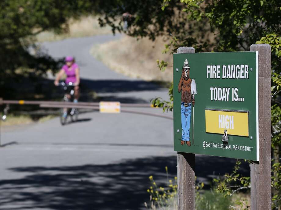 A fire warning is posted at Inspiration Point and the Nimitz Way trailhead in Tilden Regional Park near Orinda, Calif. on Saturday, June 23, 2018. A red flag warning was issued for extreme fire conditions for this week. Photo: Paul Chinn / The Chronicle