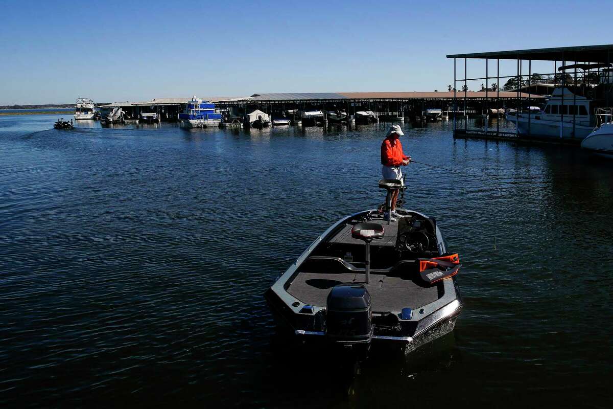 A man fishes for bass from his boat near the Walden Yacht Club on Lake Conroe Wednesday, Feb. 22, 2017 in Montgomery. ( Michael Ciaglo / Houston Chronicle )
