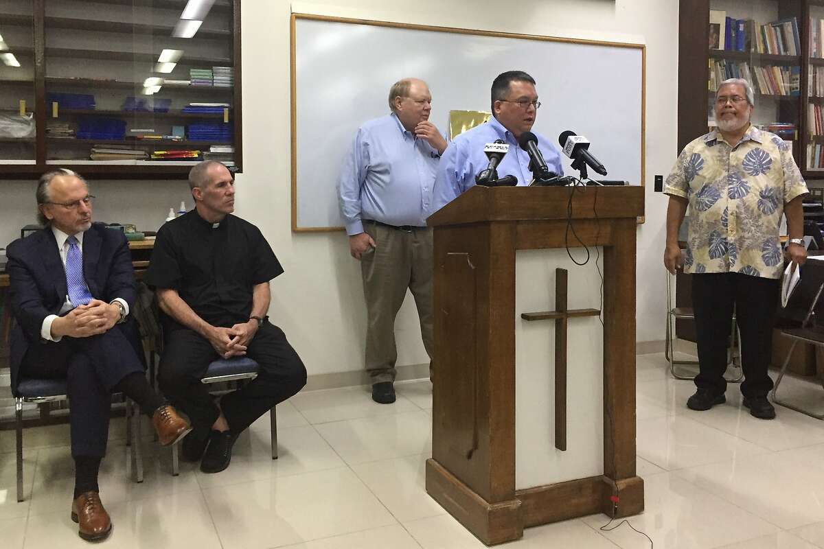 Attorney Keith Talbot speaks at a news conference in Hagatna, Guam, where the Catholic Church in Guam announced that it will file Chapter 11 reorganization bankruptcy, Wednesday, Nov. 7, 2018. The move will allow the archdiocese to avoid trial in dozens of lawsuits alleging child sexual abuse by priests and move toward settlements. Talbot said the funds for future victims claims will come from the sale of non-essential church properties and insurance. (AP Photo/Grace Garces Bordallo)