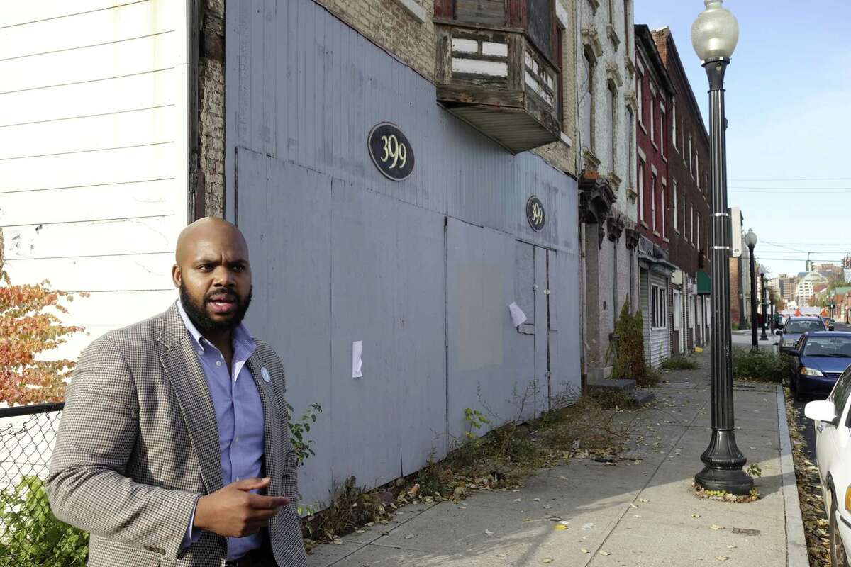 Jahkeen Hoke, COO and strategic planning and development for Upstate New York Black Chamber of Commerce, stands on South Pearl Street as he talks about plans to bring entrepreneurs to the empty buildings, during an interview on Wednesday, Nov. 7, 2018, in Albany, N.Y. Hoke grew up in this neighborhood. (Paul Buckowski/Times Union)