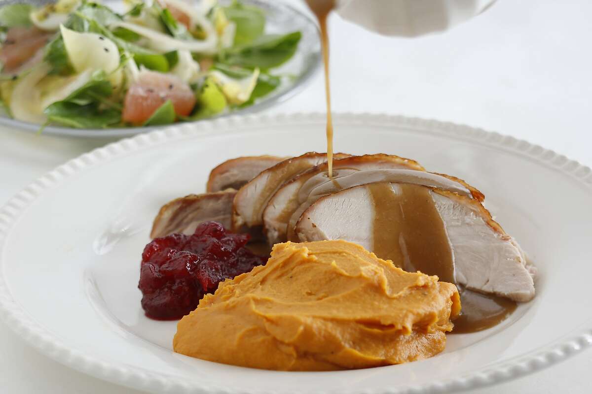 A classic sight: Roast turkey slices with gravy and sweet Potato puree with brown sugar and cream.