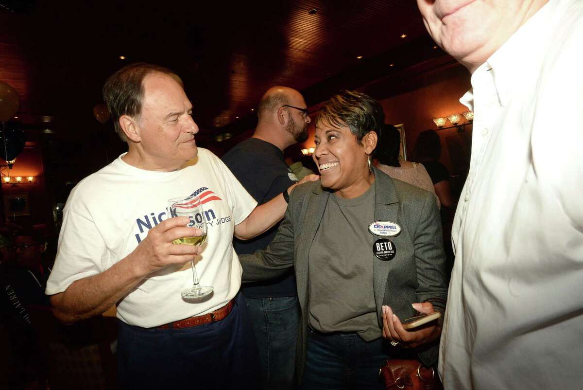 Jefferson County Judge Democratic candidate Nick Lampson jokes with Jackie Simien during a Democratic watch party at Suga's. Photo taken Tuesday, November 6, 2018 Kim Brent/The Enterprise